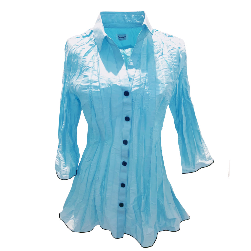 Tunic shaped blouse with three quarter sleeves, point collar in color ice, which can be describes as a light reflecting blue. Buttons and seems are black.