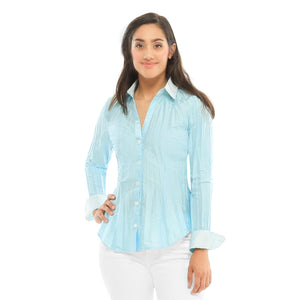 Model is wearing Belden, Ice blouse paired with a white pair of jeans.